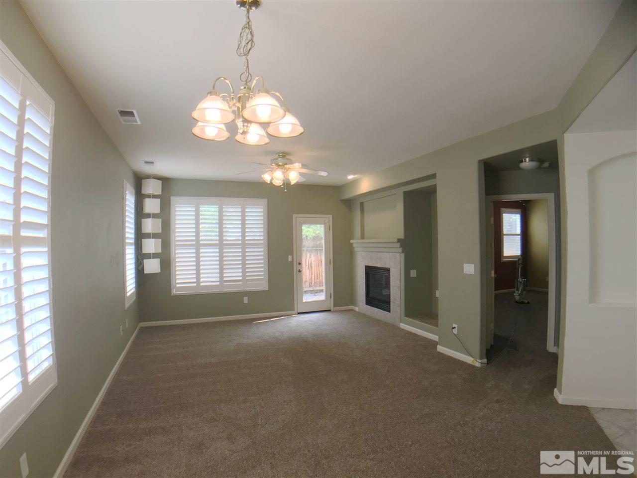 1615 Mountain Lane Reno, NV 89521 - Photo 3 of 20 a view of an empty room with a window and a kitchen