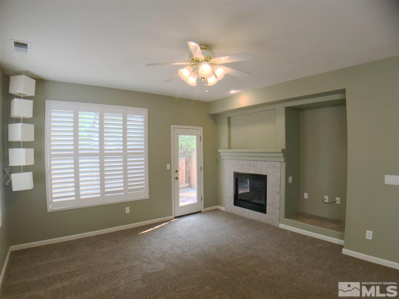 1615 Mountain Lane Reno, NV 89521 - Photo 4 of 20 a view of an empty room with window and fireplace
