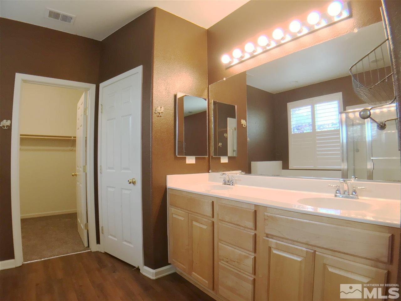 1615 Mountain Lane Reno, NV 89521 - Photo 8 of 20 a bathroom with a double vanity sink and a mirror