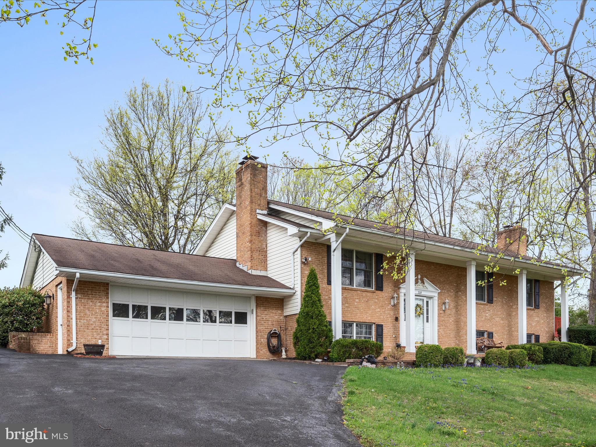 209 Sterrett Lane Winchester, VA 22603 - Photo 1 of 52 a view of a white house with large windows and a large tree