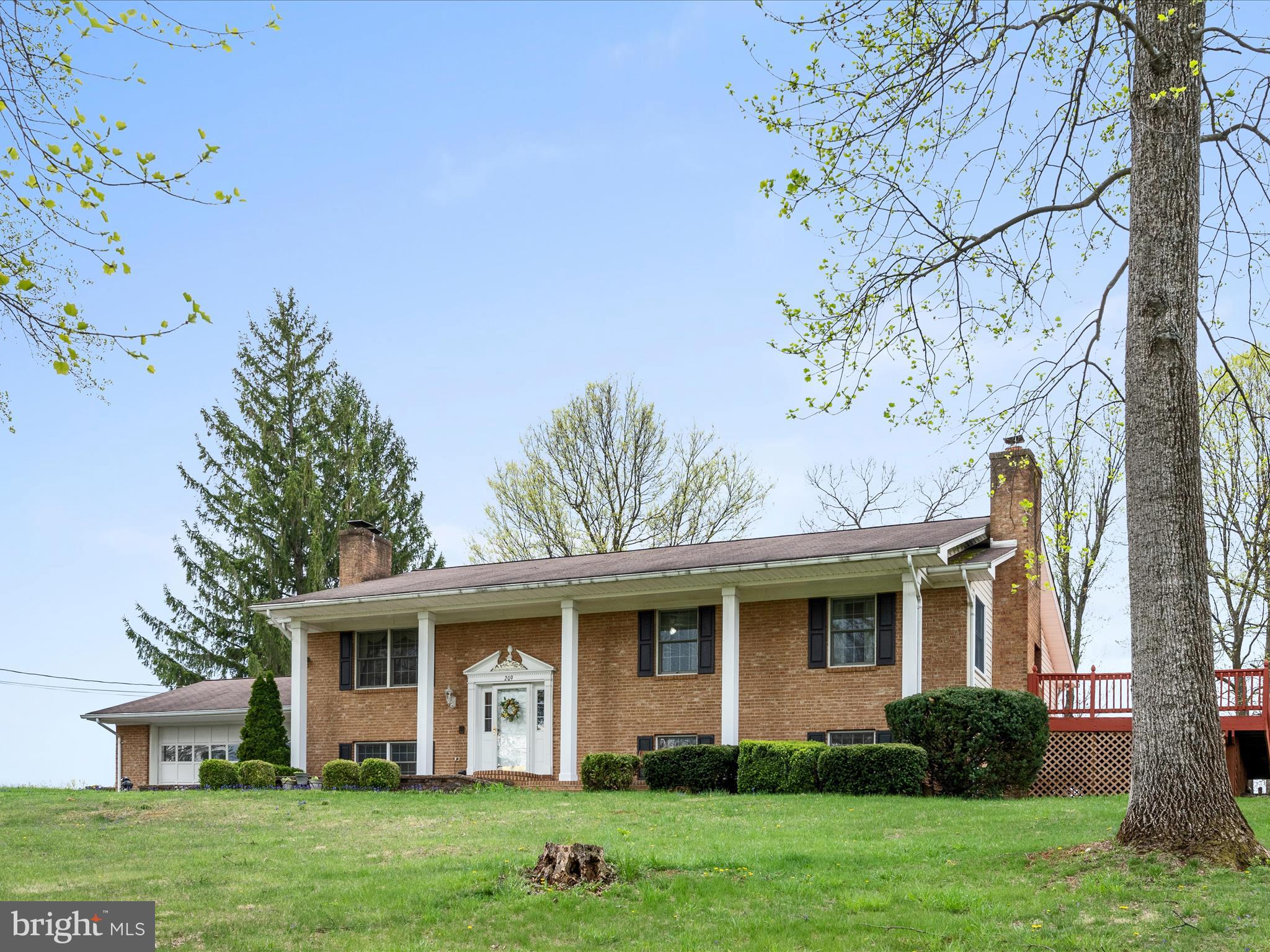 209 Sterrett Lane Winchester, VA 22603 - Photo 2 of 52 a front view of a house with garden