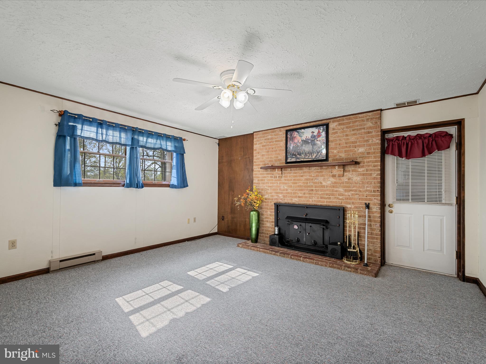209 Sterrett Lane Winchester, VA 22603 - Photo 31 of 52 a living room with furniture and a fireplace