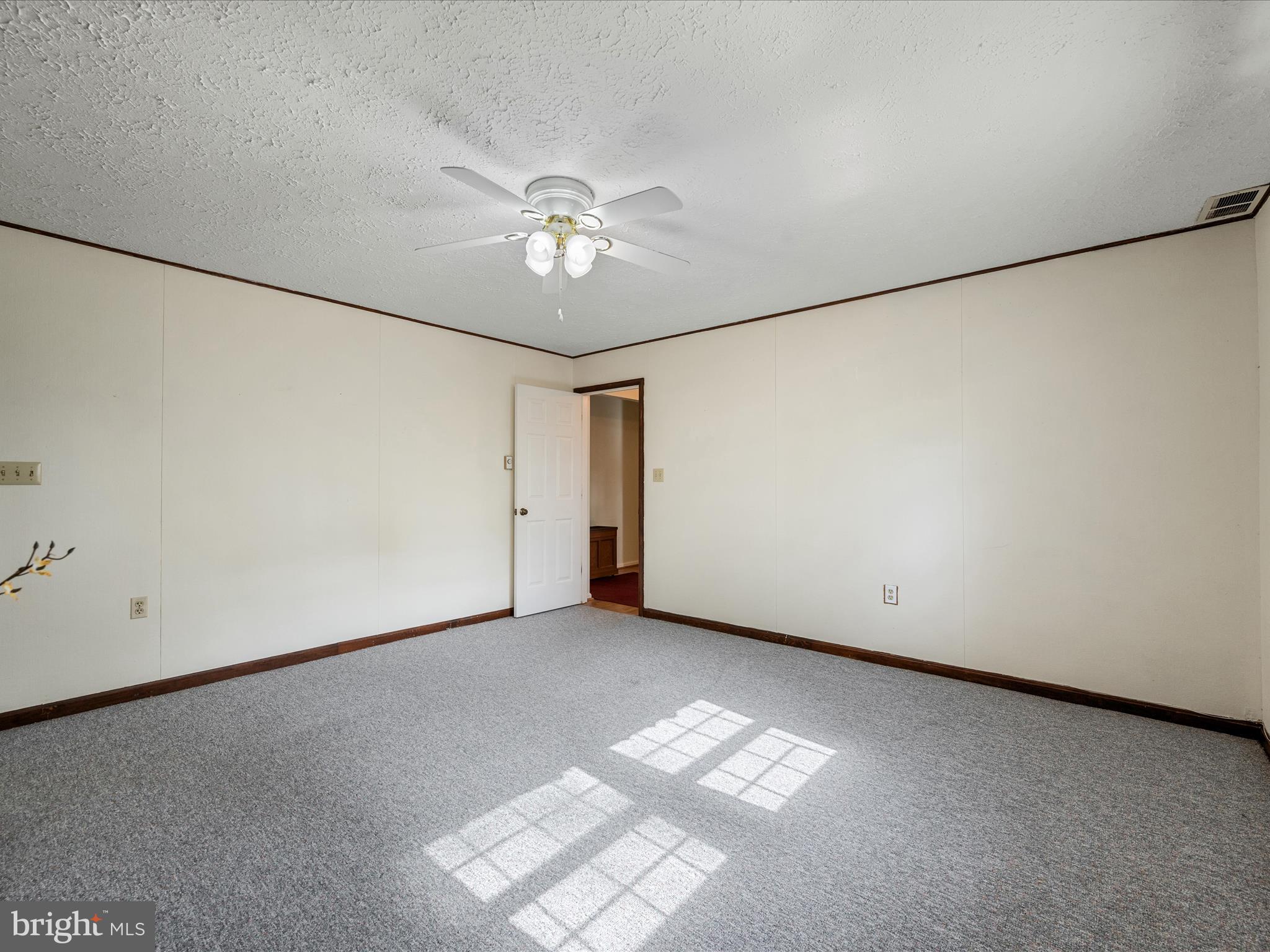 209 Sterrett Lane Winchester, VA 22603 - Photo 32 of 52 an empty room with a ceiling fan and a window