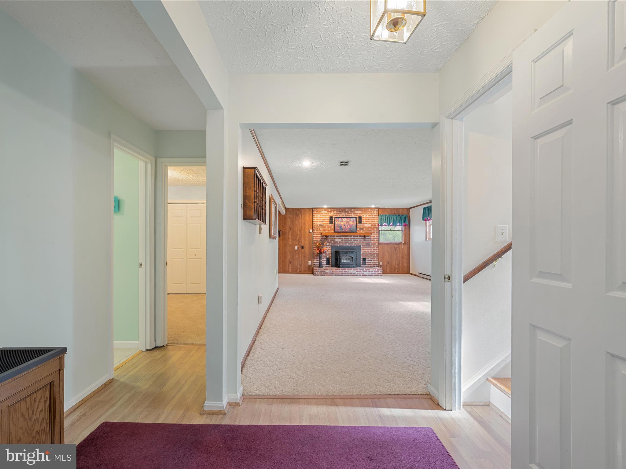 209 Sterrett Lane Winchester, VA 22603 - Photo 33 of 52 a view of a hallway with wooden floor and a living room
