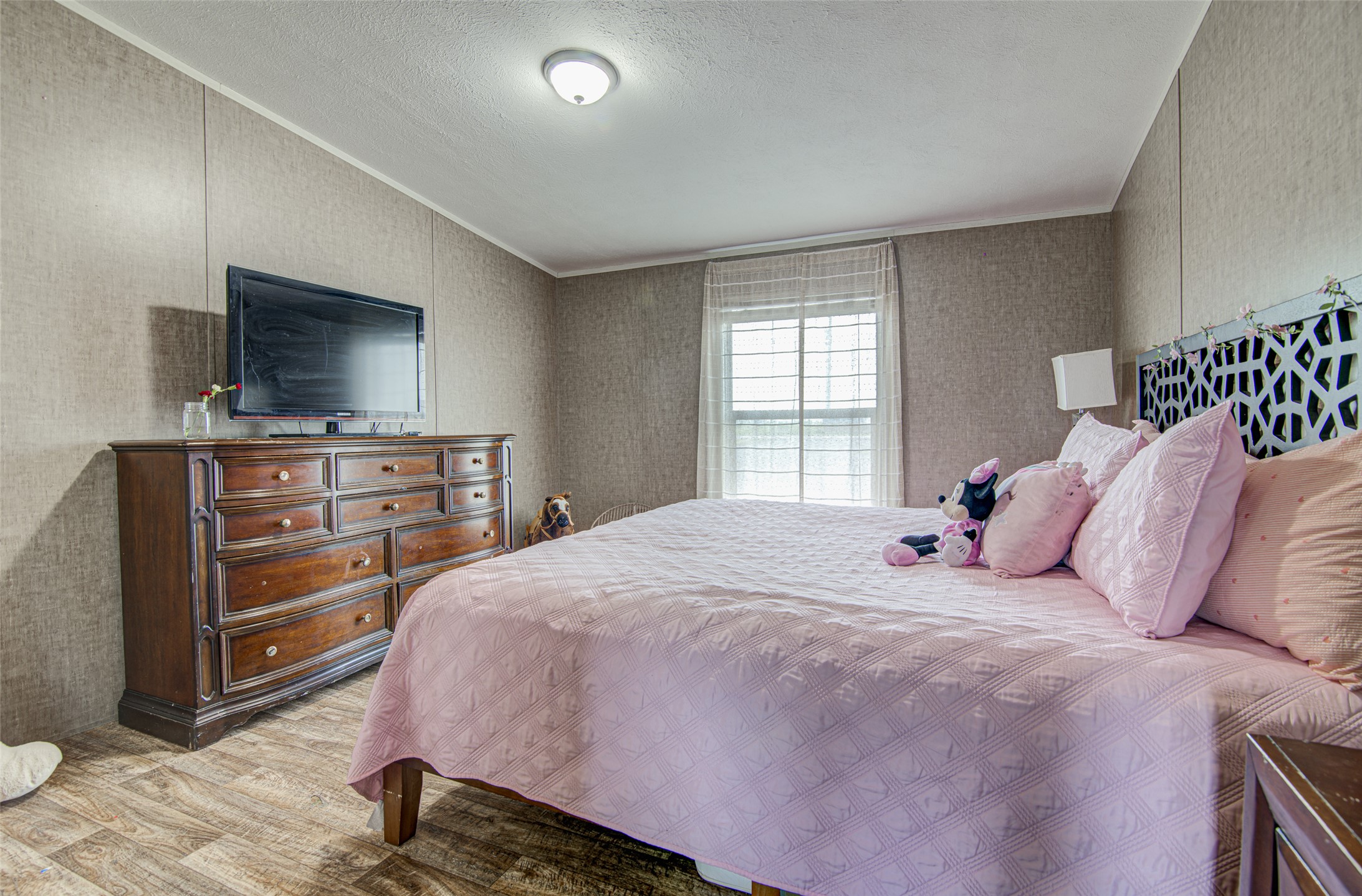 445 Rancho Linda Drive Lockhart, TX 78644 - Photo 22 of 26 Naturally illuminated sleeping quarters feature resilient vinyl plank flooring.