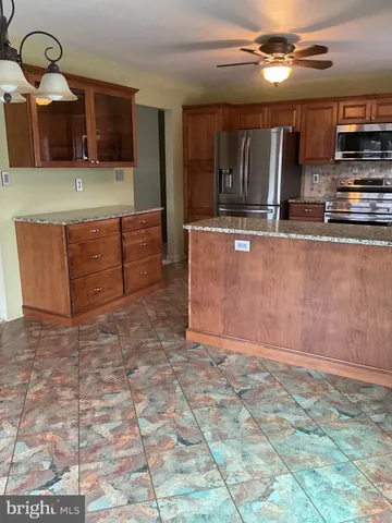 a kitchen with granite countertop a stove a sink and a granite counter tops