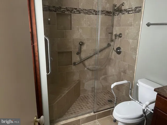 a bathroom with a toilet and a shower
