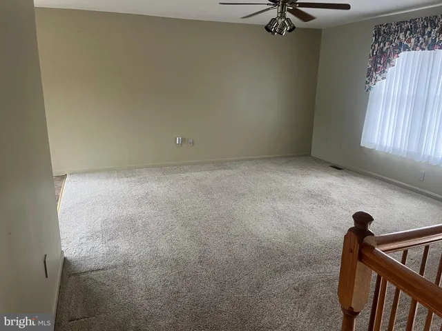 a view of an empty room and a window