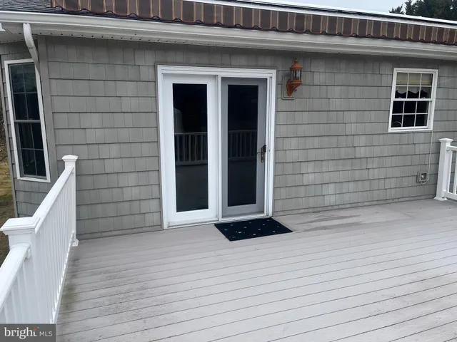 a view of wooden door and a wooden bench