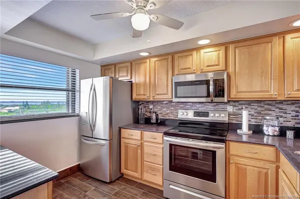 a kitchen with stainless steel appliances a stove microwave and refrigerator