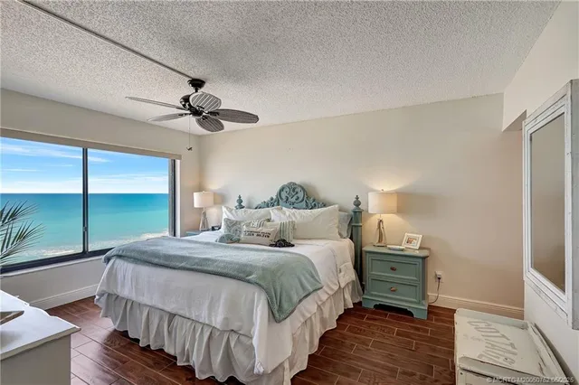 a bedroom with a bed and a ceiling fan