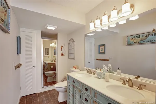 a bathroom with a sink a toilet and a mirror