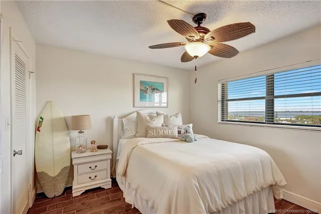 a bedroom with a large bed and a window