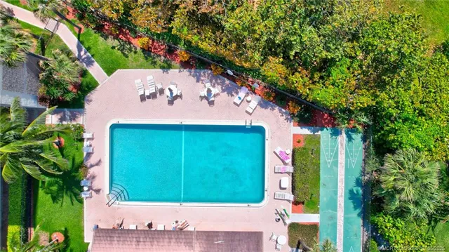 an aerial view of residential house with outdoor space and swimming pool