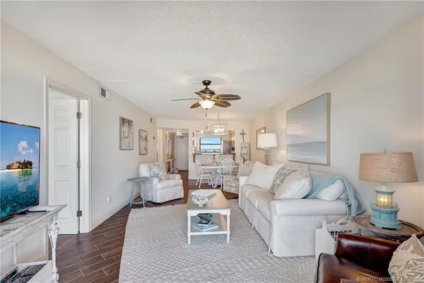 a living room with furniture and a chandelier