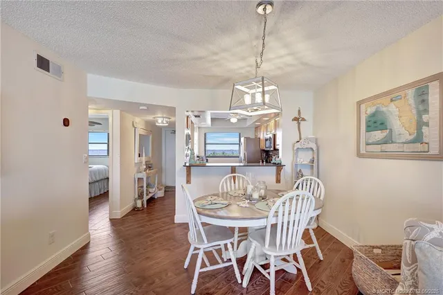 a view of a dining room with furniture wooden floor and chandelier