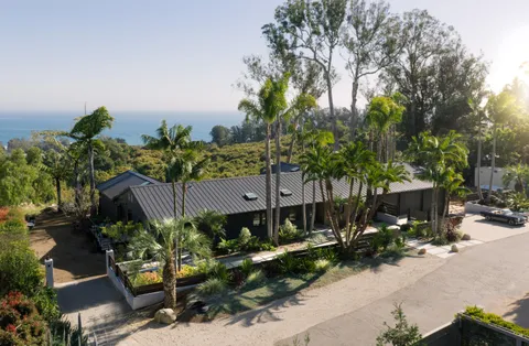 a view of a house with a yard and garden