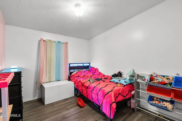 a bed room with a bed and a chair