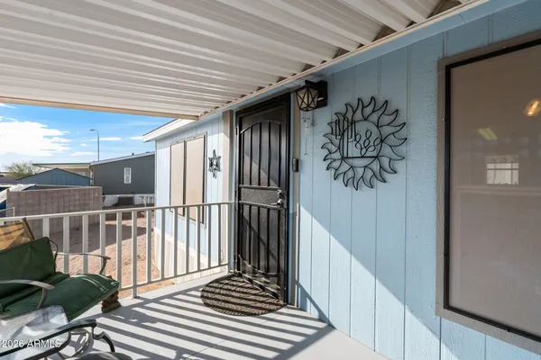 a living room with furniture and a flat screen tv with wooden floor