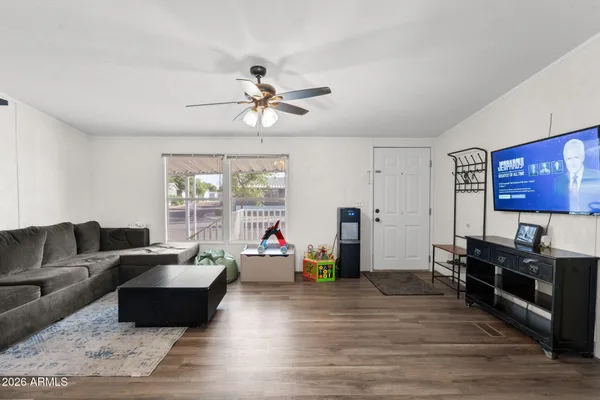 a living room with furniture and a wooden floor