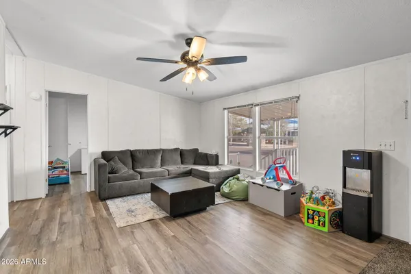 a living room with furniture and kitchen view