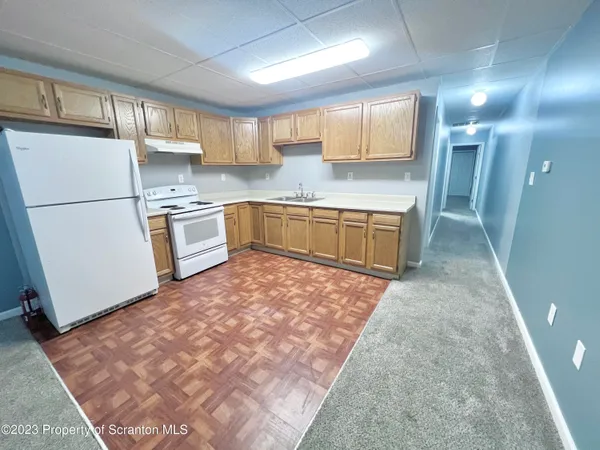 a kitchen with a refrigerator and a sink