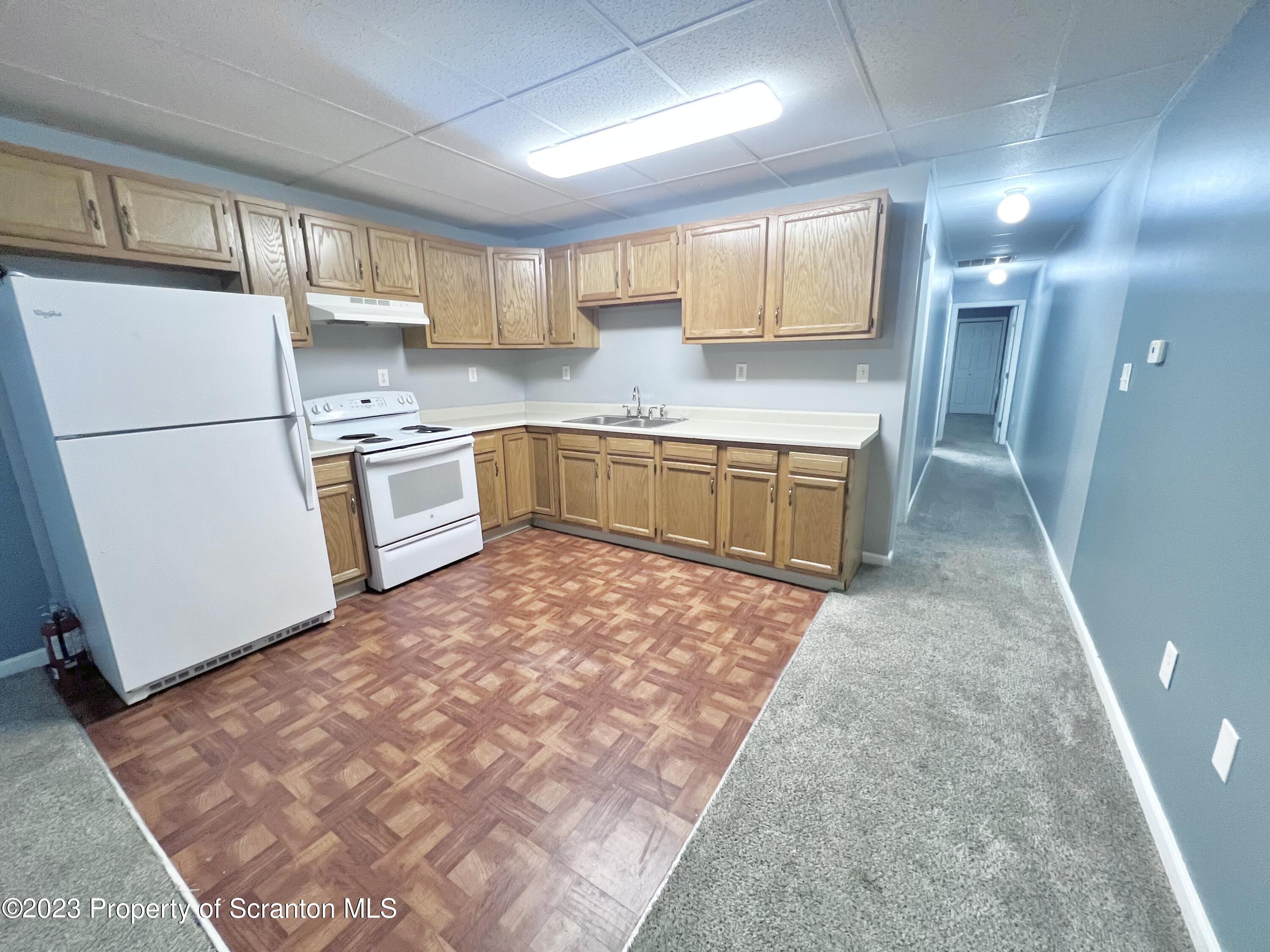 609 Mill Street, Unit 6 Dunmore, PA 18512 - Photo 2 of 10 a kitchen with a refrigerator and a sink