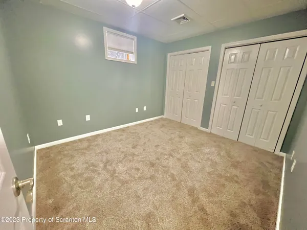 a view of a big room with window and stairs