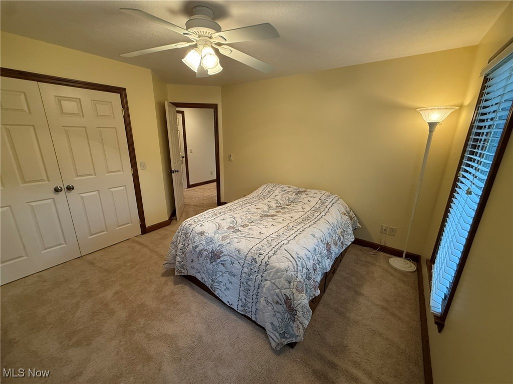 2597 Pyle Road Dover, OH 44622 - Photo 37 of 50 Bedroom with light carpet, a closet, and ceiling fan