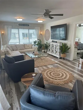 a living room with furniture and a large mirror