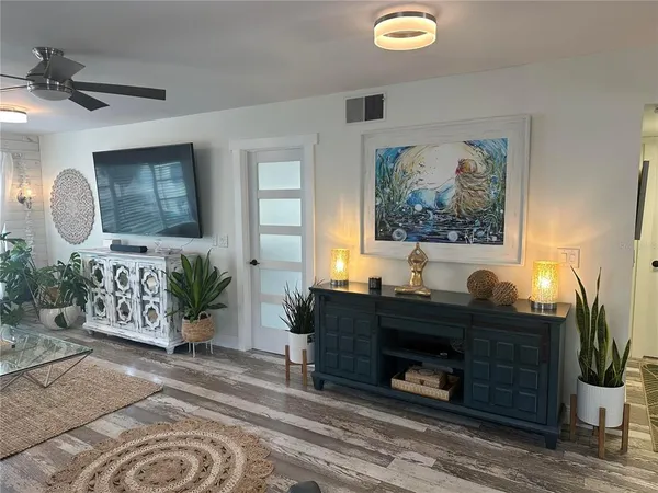 a living room with furniture and a mirror