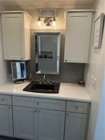 a white toilet sitting next to a bathroom sink
