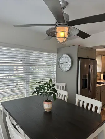 a view of a dining room with furniture and chandelier