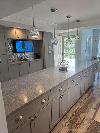 a kitchen with stainless steel appliances granite countertop cabinets a window and a counter space