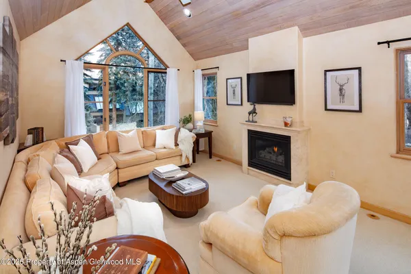 a living room with furniture fireplace and a flat screen tv