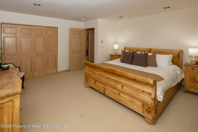 a bed room with a bed and a chair