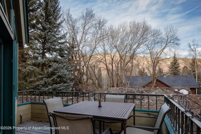 a view of a patio with a table and chairs