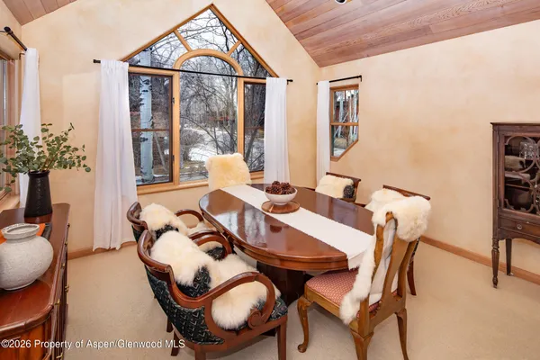 a view of a dining room with furniture window and outside view