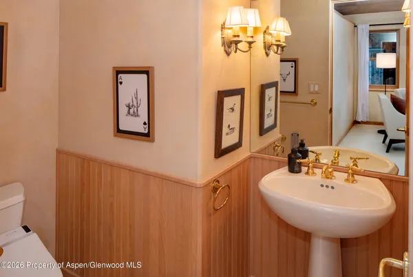 a bathroom with a sink a mirror and a toilet