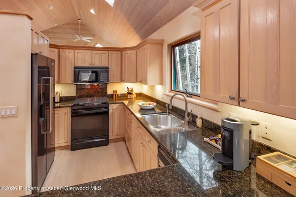 a kitchen with a sink stove and refrigerator
