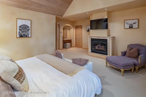 a bedroom with a bed and a fireplace
