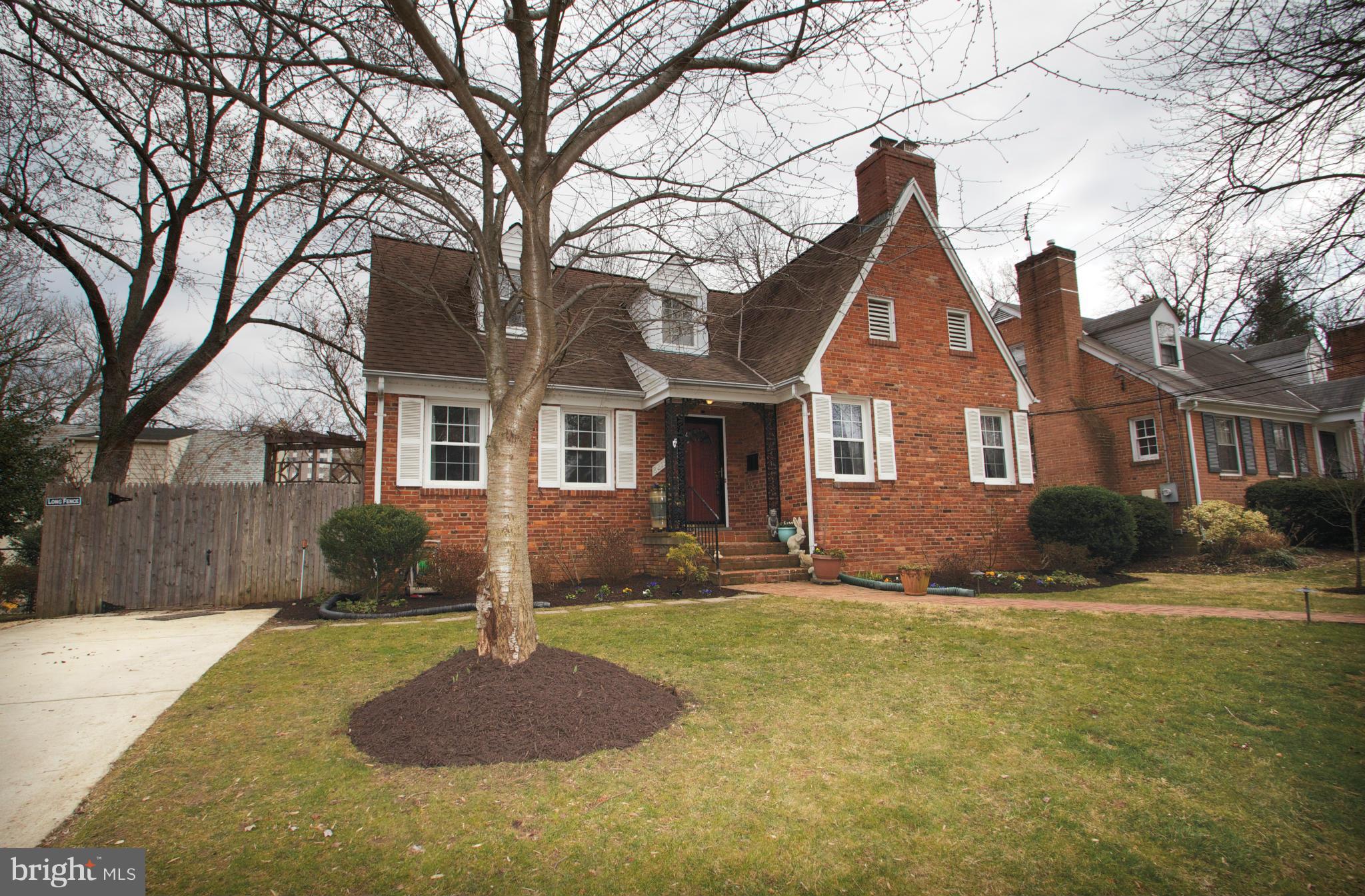 8215 Maple Ridge Road Bethesda, MD 20814 - Photo 1 of 23 a front view of a house with a yard