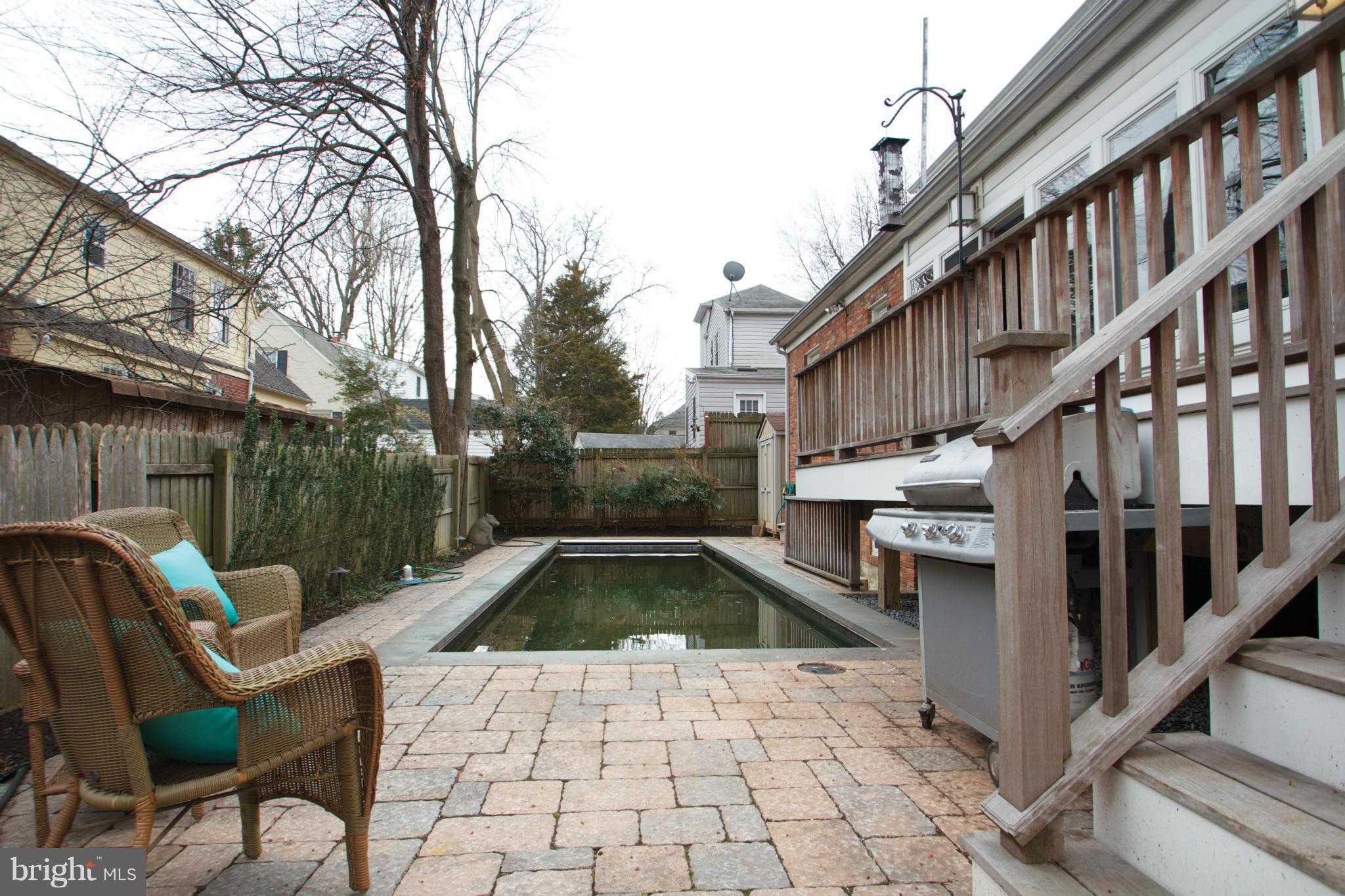 8215 Maple Ridge Road Bethesda, MD 20814 - Photo 13 of 23 a view of a chairs and tables in the patio with swimming pool
