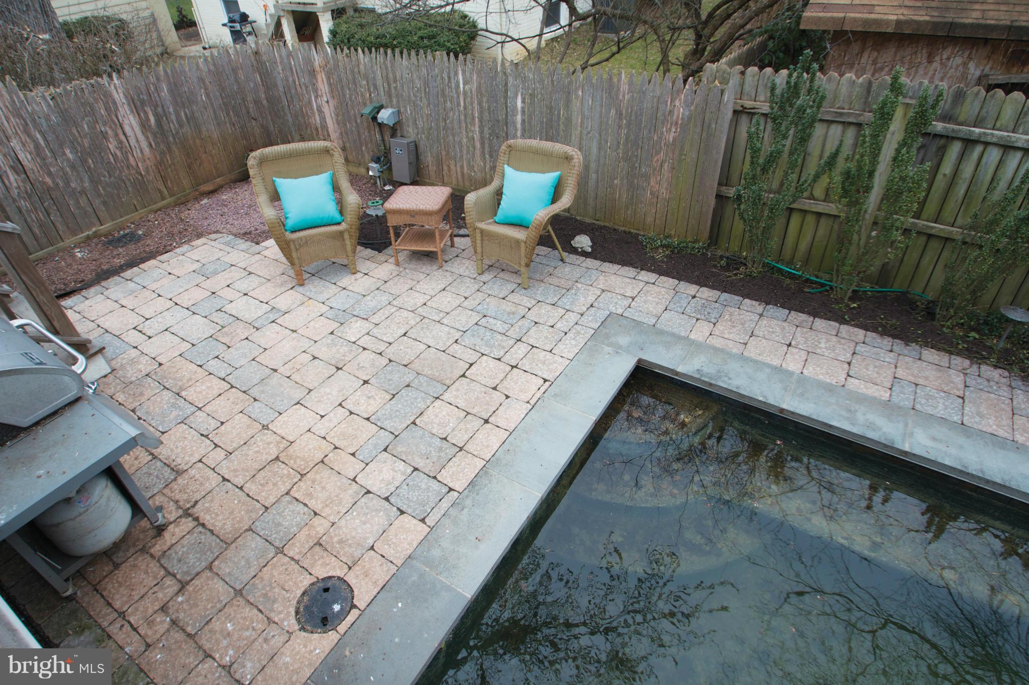 8215 Maple Ridge Road Bethesda, MD 20814 - Photo 15 of 23 a backyard of a house with chairs and wooden fence
