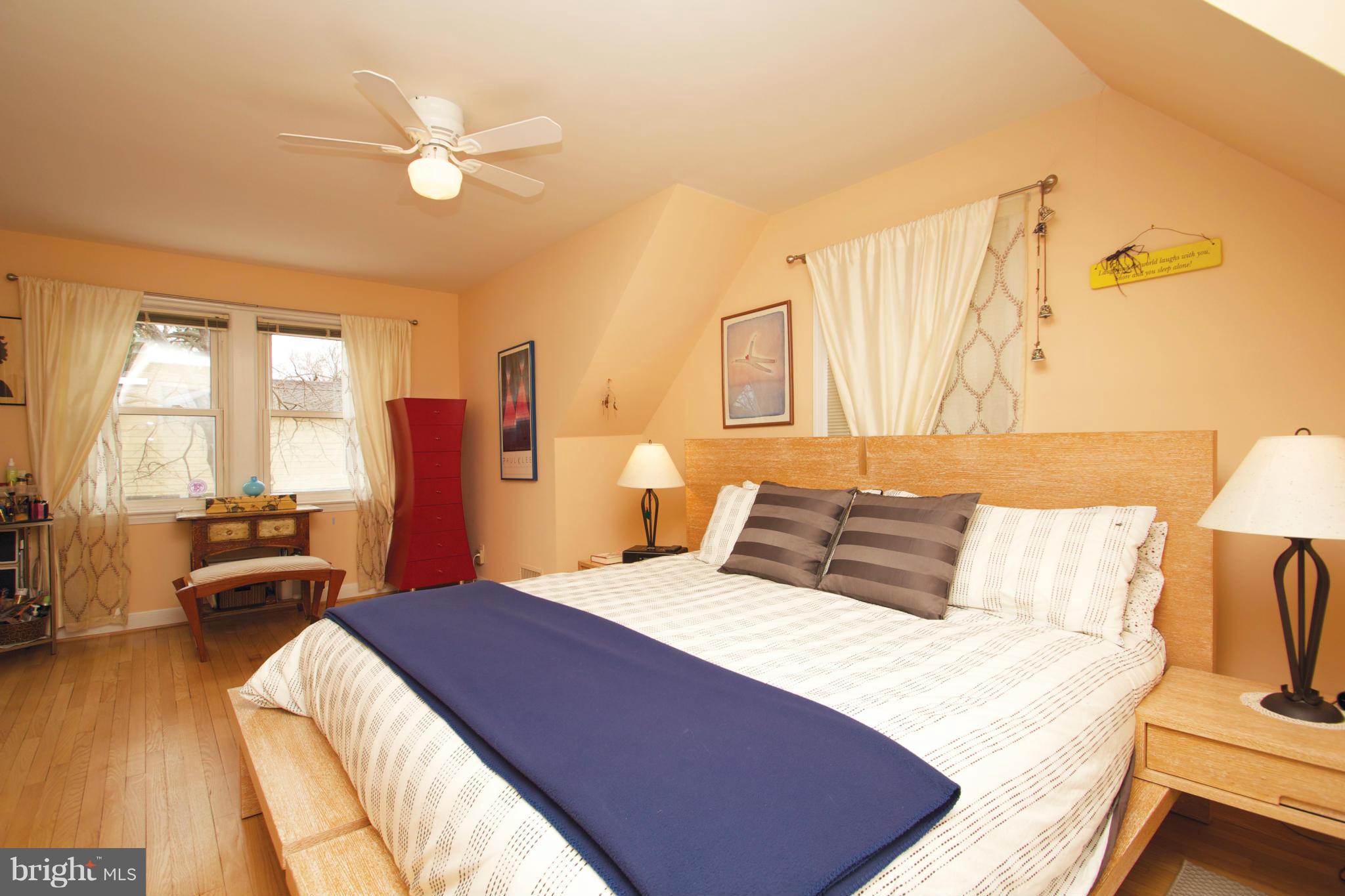 8215 Maple Ridge Road Bethesda, MD 20814 - Photo 17 of 23 a bedroom with a bed and wooden floor