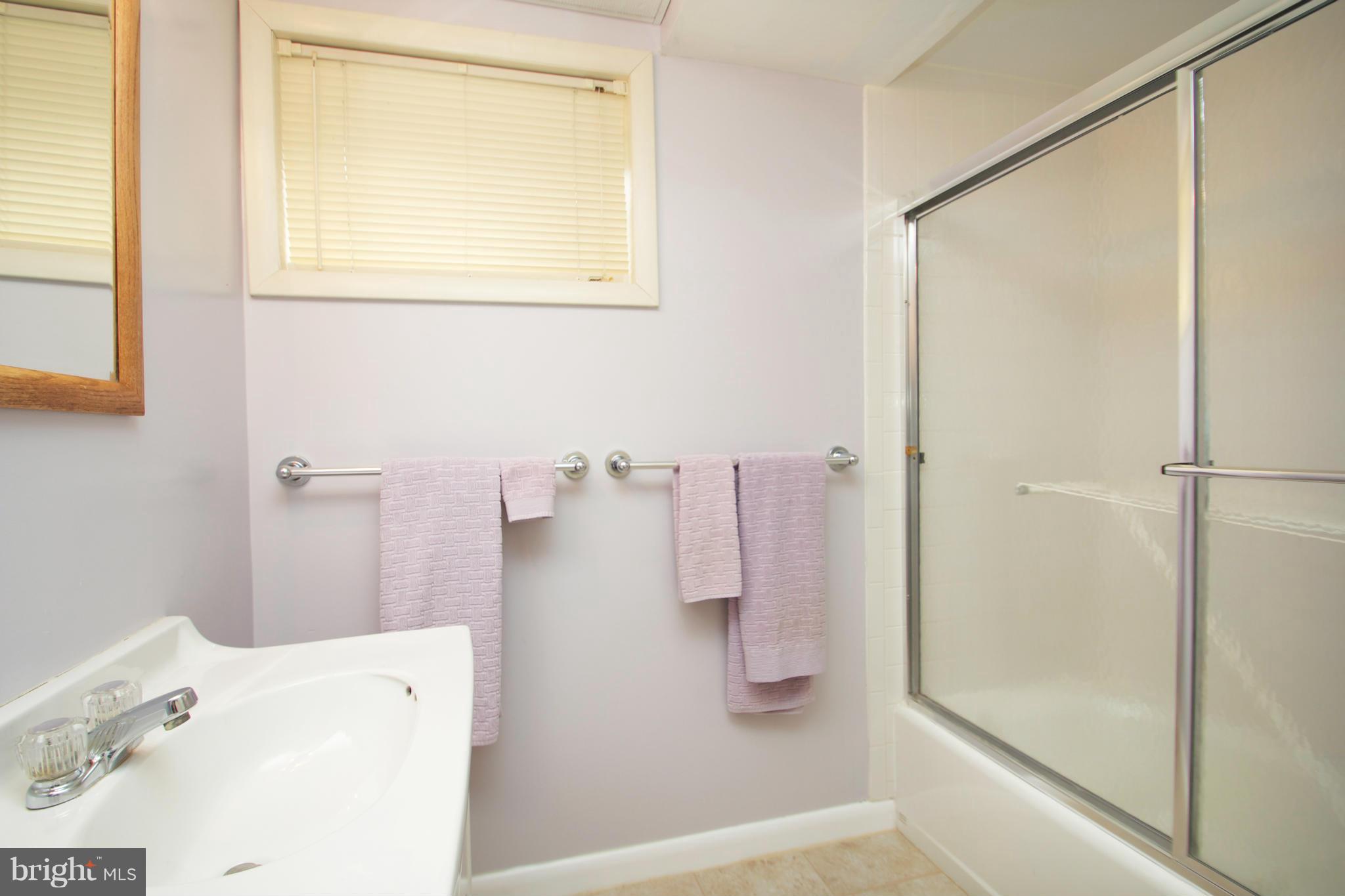 8215 Maple Ridge Road Bethesda, MD 20814 - Photo 18 of 23 a bathroom with a bathtub and a shower