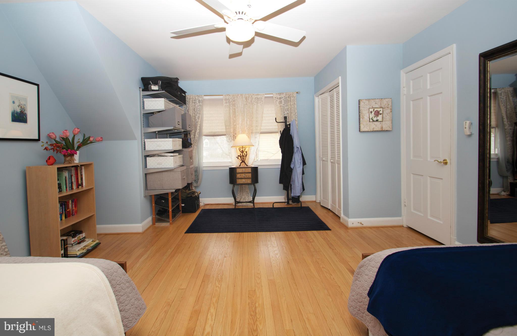 8215 Maple Ridge Road Bethesda, MD 20814 - Photo 20 of 23 a bedroom with a bed and a chandelier
