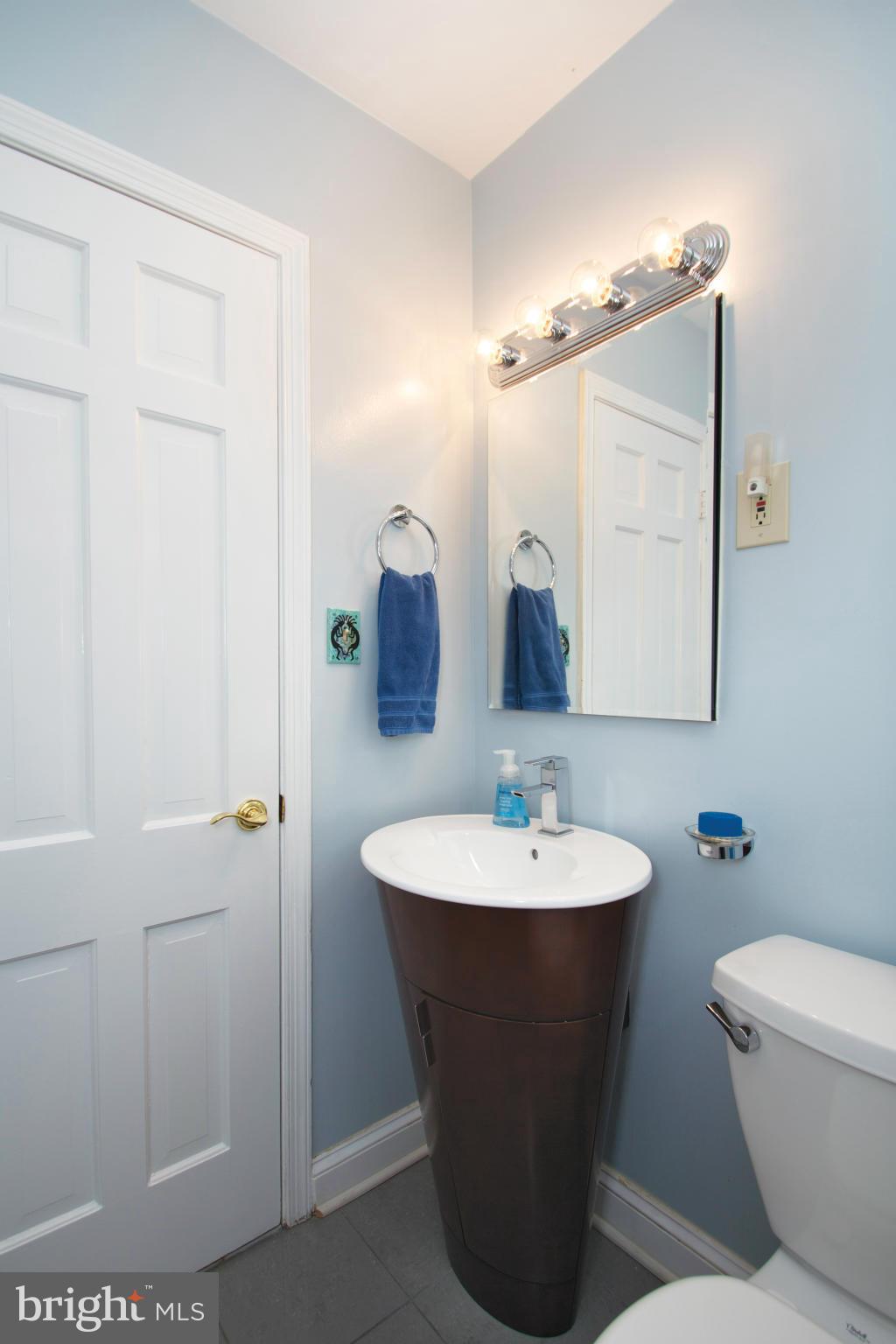 8215 Maple Ridge Road Bethesda, MD 20814 - Photo 21 of 23 a bathroom with a sink and a mirror