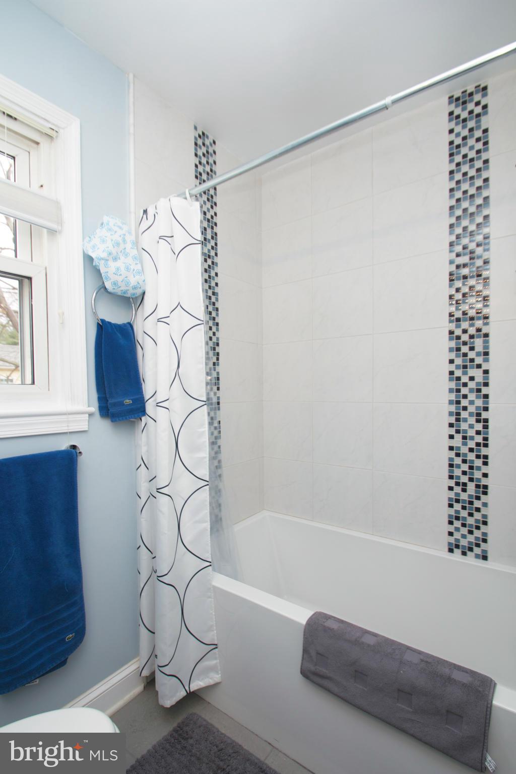8215 Maple Ridge Road Bethesda, MD 20814 - Photo 22 of 23 a bathroom with a bathtub and shower