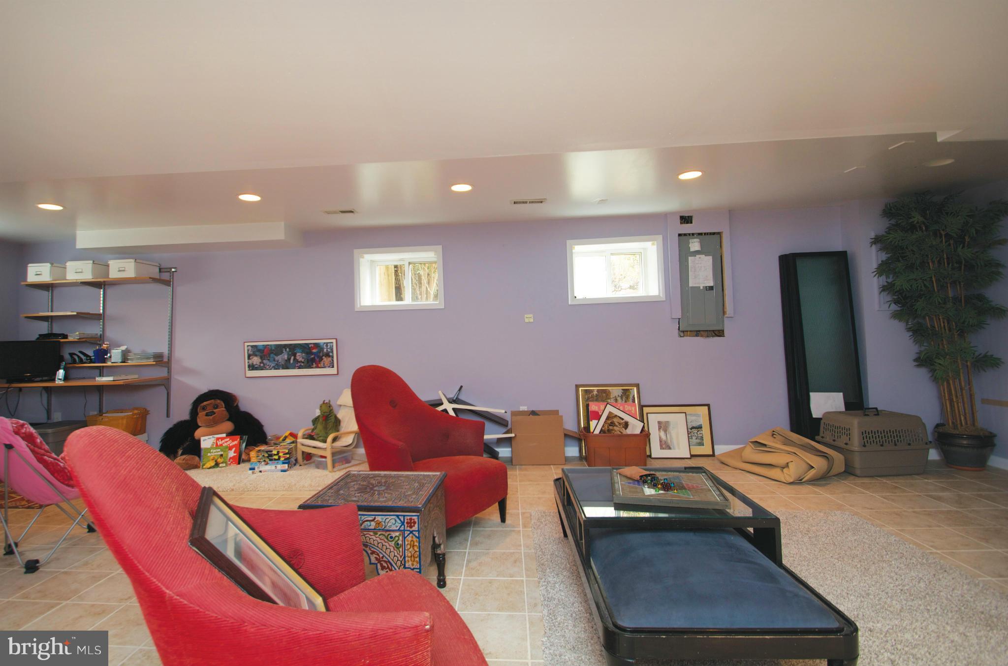 8215 Maple Ridge Road Bethesda, MD 20814 - Photo 23 of 23 a living room with furniture and a flat screen tv